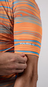 Close up of left sleeve and Varlo logo on the new 2025 gravel series pioneer cycling jersey in path orange.