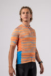 In studio front side view of the new mens pioneer gravel jersey in path orange designed by Varlo.