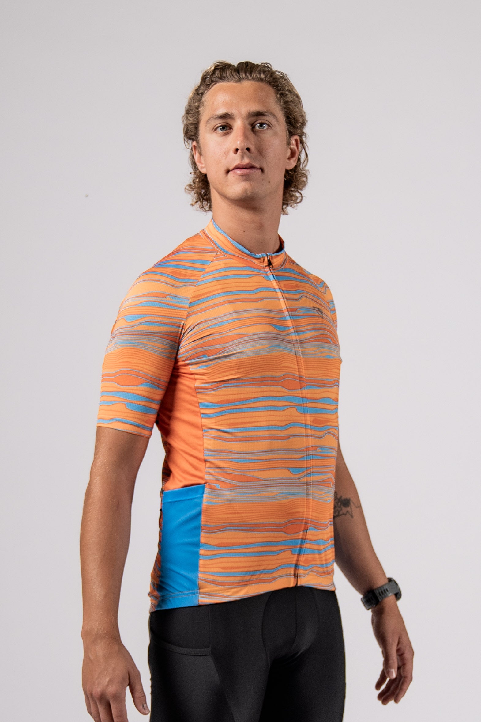 In studio front side view of the new mens pioneer gravel jersey in path orange designed by Varlo.