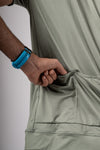 Close up view featuring the rear pockets on the green men's Varlo cycling shirt.