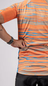 The rear pocket features from the Varlo 2025 gravel series cycling jersey, the pioneer gravel jersey in path orange.