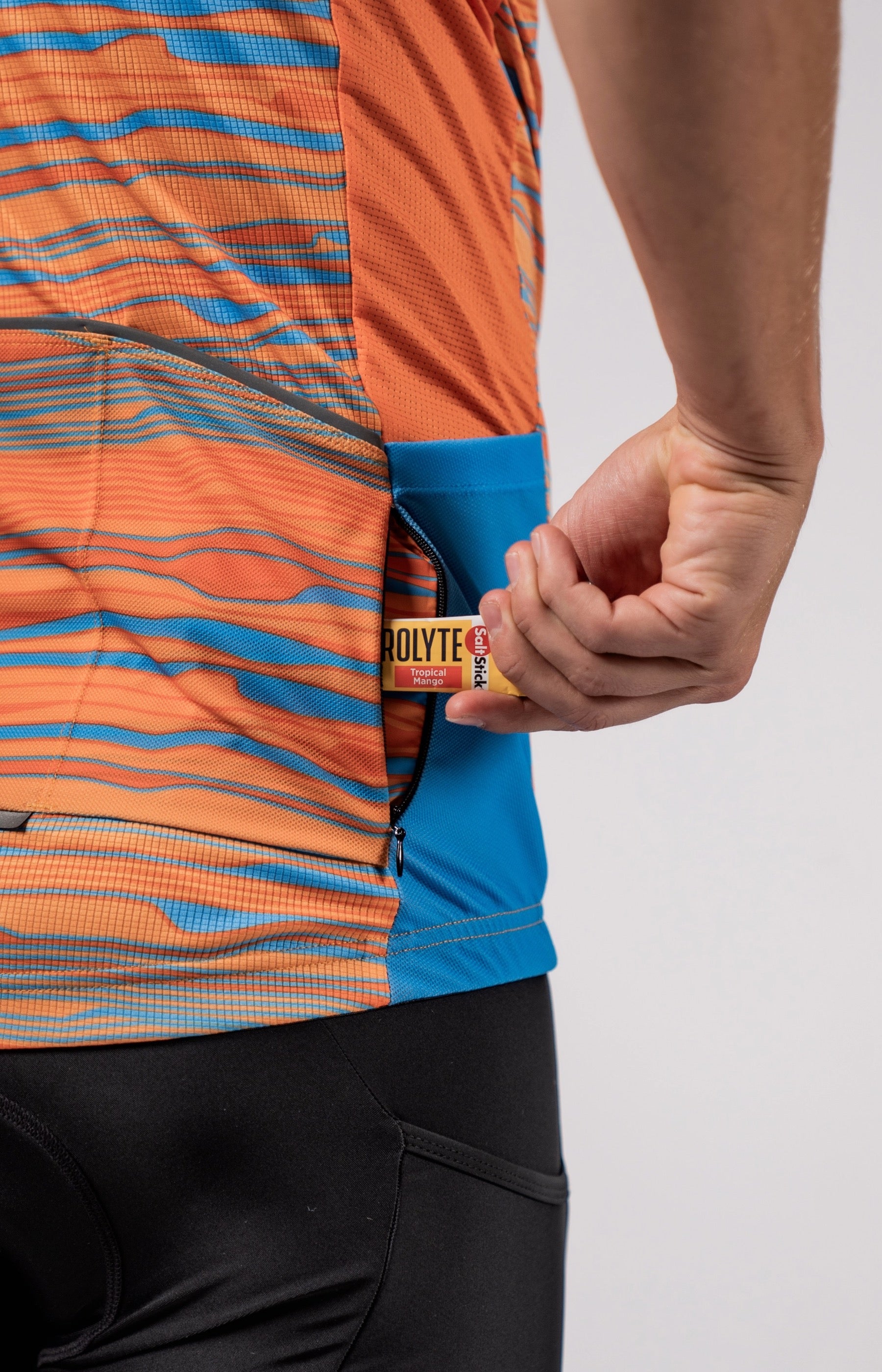 The back right zipper pocket feature on the Varlo Pioneer Gravel Jersey in path orange.
